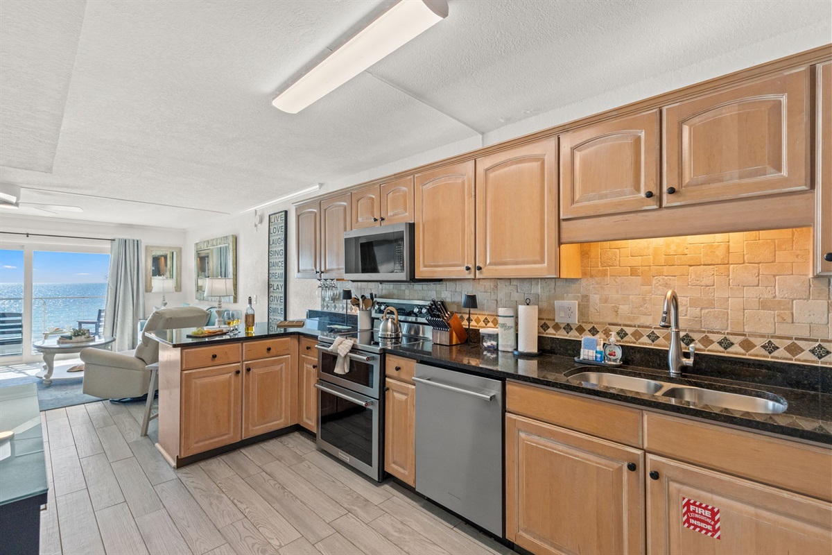 Fully appointed kitchen with brand-new KitchenAid appliances and a Cuisinart combo coffee maker, plus all the extras you actually use—blender, crock pot, mixer, mixing bowls, baking sheets, wine glasses, and kid-friendly dishes and cups—ready for everythin