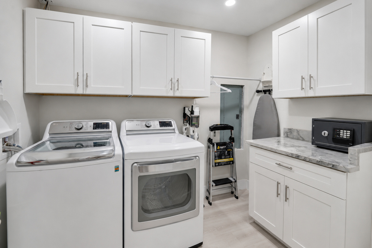 In-home laundry with cabinets and hanging space makes it easier to pack light and keep beach towels and clothes fresh.