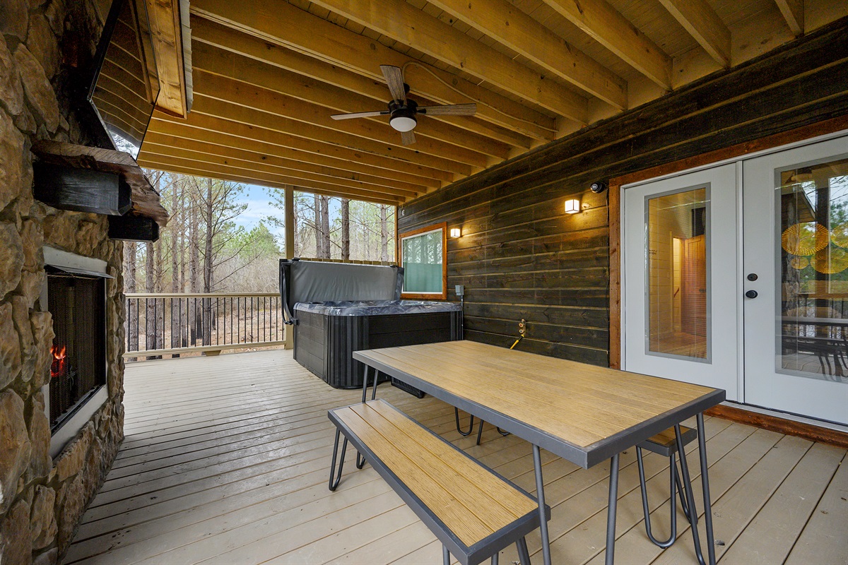 An open-air hangout built for comfort and connection — complete with a spacious dining setup, relaxed seating areas, a hot tub, fire feature, and outdoor TV for laid-back evenings under the sky. 🌙