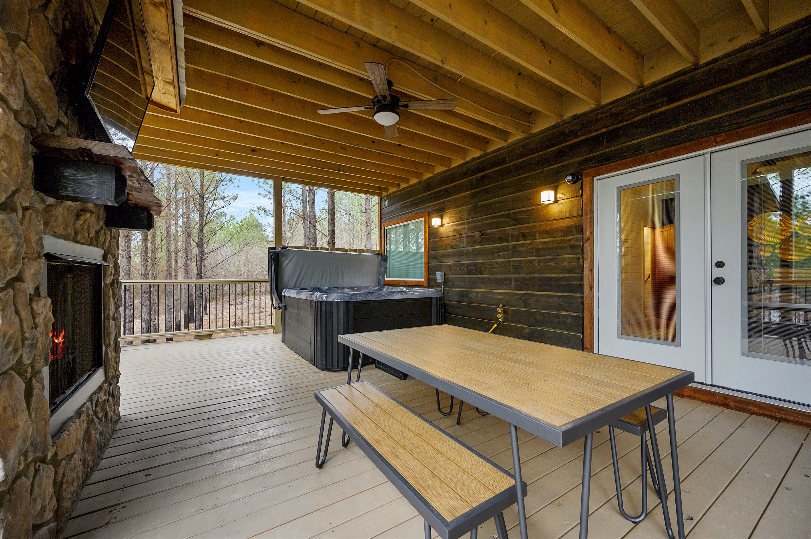 An open-air hangout built for comfort and connection — complete with a spacious dining setup, relaxed seating areas, a hot tub, fire feature, and outdoor TV for laid-back evenings under the sky. 🌙
