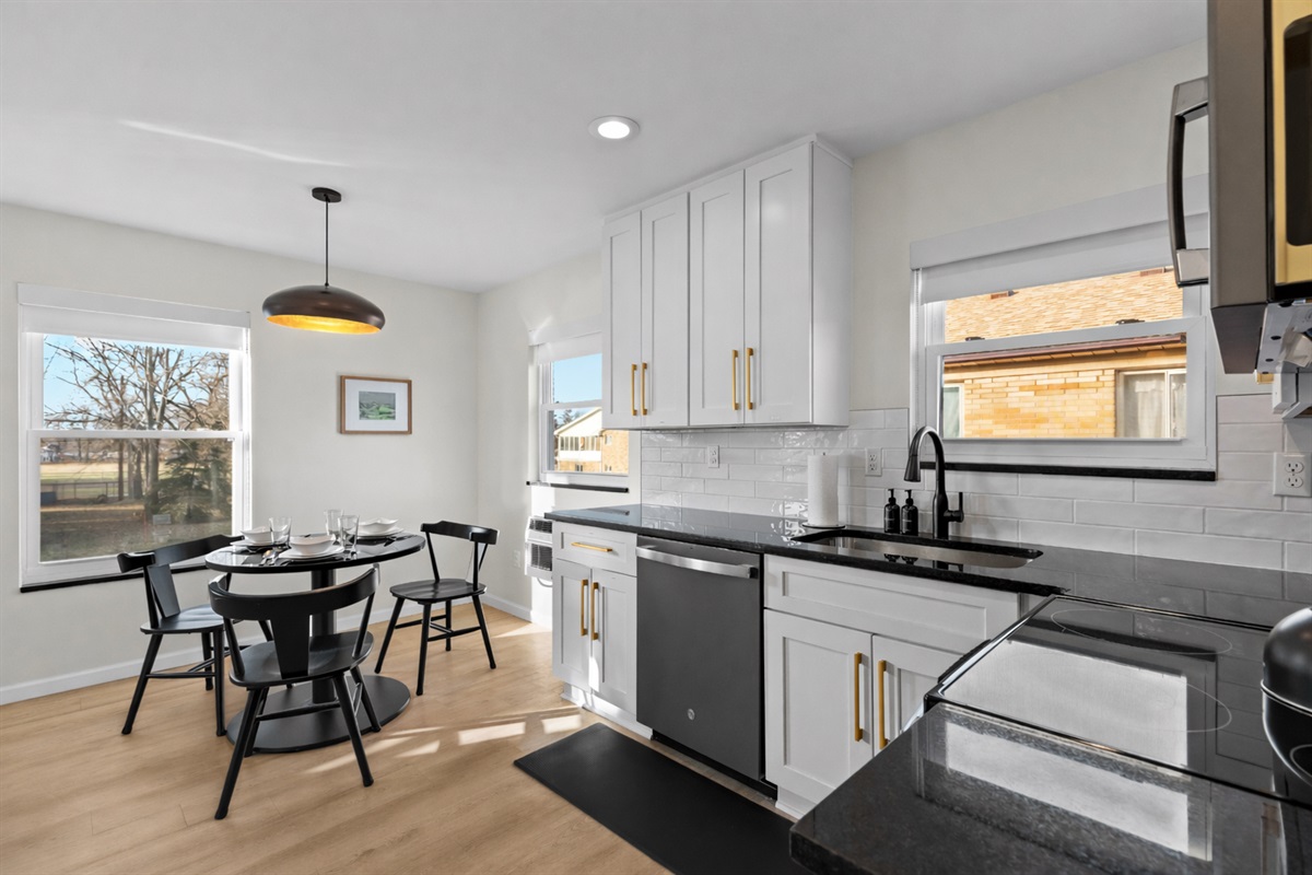Bright, open kitchen and dining area with modern finishes, sunlit windows, and a cozy table—perfect for cooking, dining, and relaxed everyday living.