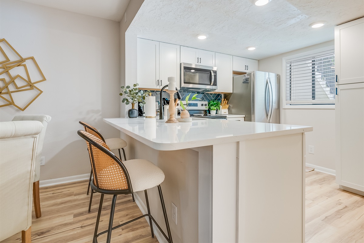 Pull up a seat at the granite island—perfect for casual bites or morning coffee.