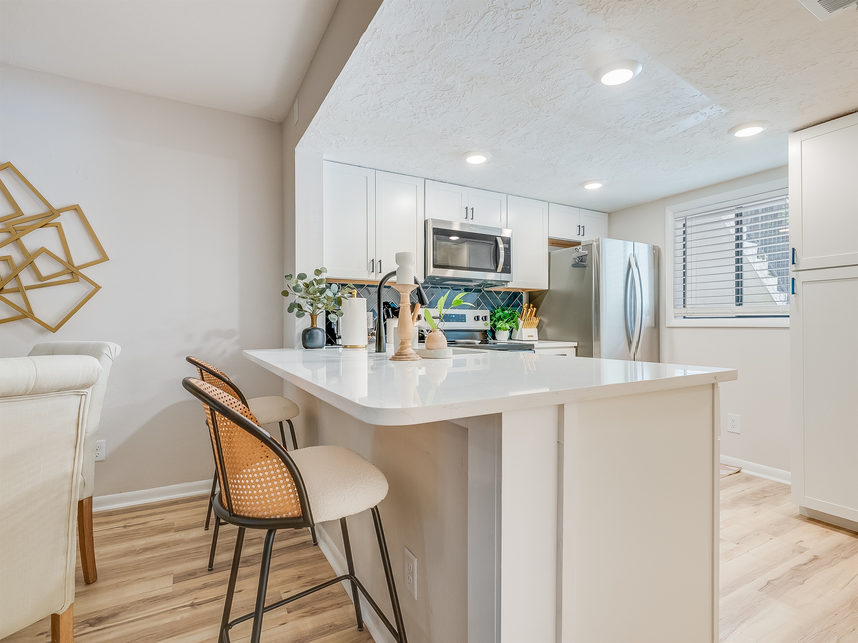 Pull up a seat at the granite island—perfect for casual bites or morning coffee.