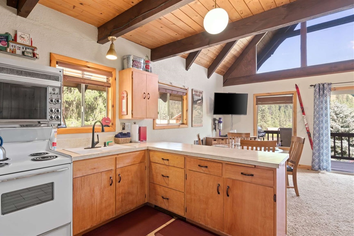 Functional kitchen layout with plenty of counter space and rustic design.