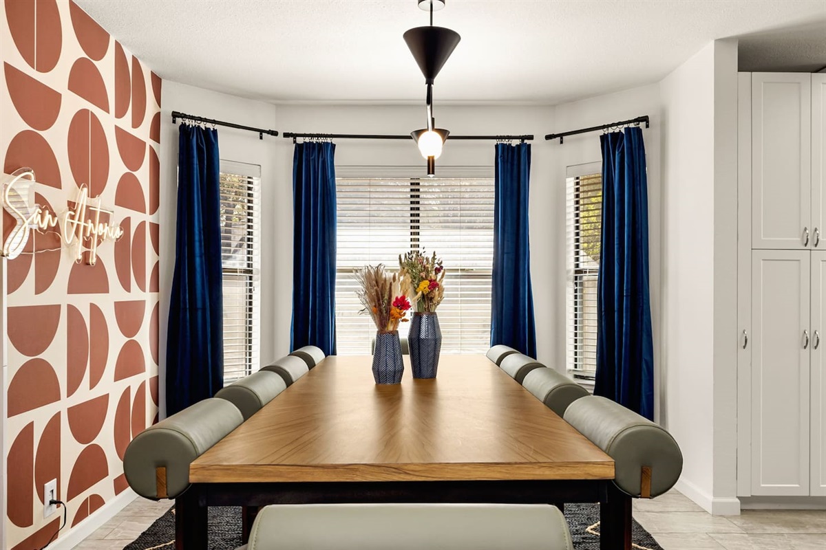  Bright and inviting dining space with natural light and seating for 10—perfect for sharing meals, stories, and celebrations with your group. A stylish spot to gather before a game, meeting, or night on the town.