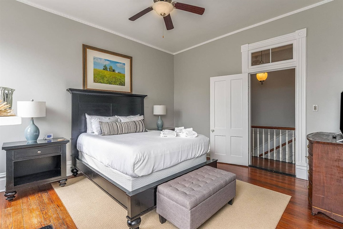 Well appointed bedroom with a queen mattress and high-end furnishings.  Two large windows between the ornate slate fireplace invite you in to kick your feet up and watch the game, read a book, or take a guilt-free nap.