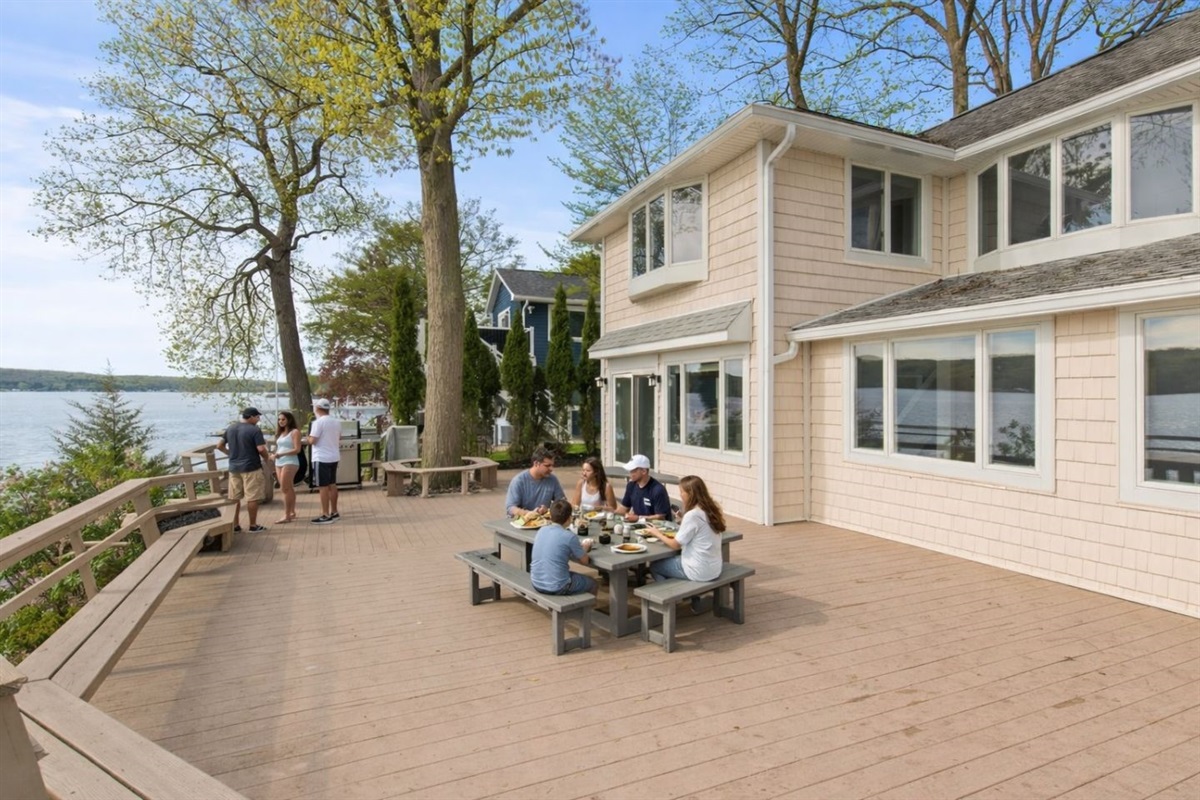Spacious outdoor deck with ample seating and stunning lake views. Ideal for BBQs, outdoor dining, and soaking up the sun. Perfect for gatherings and enjoying the great outdoors!