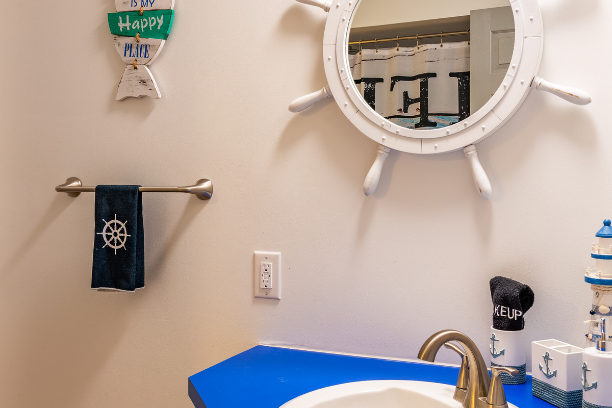 The downstairs common bathroom adds cheerful nautical details and another convenient sink area.