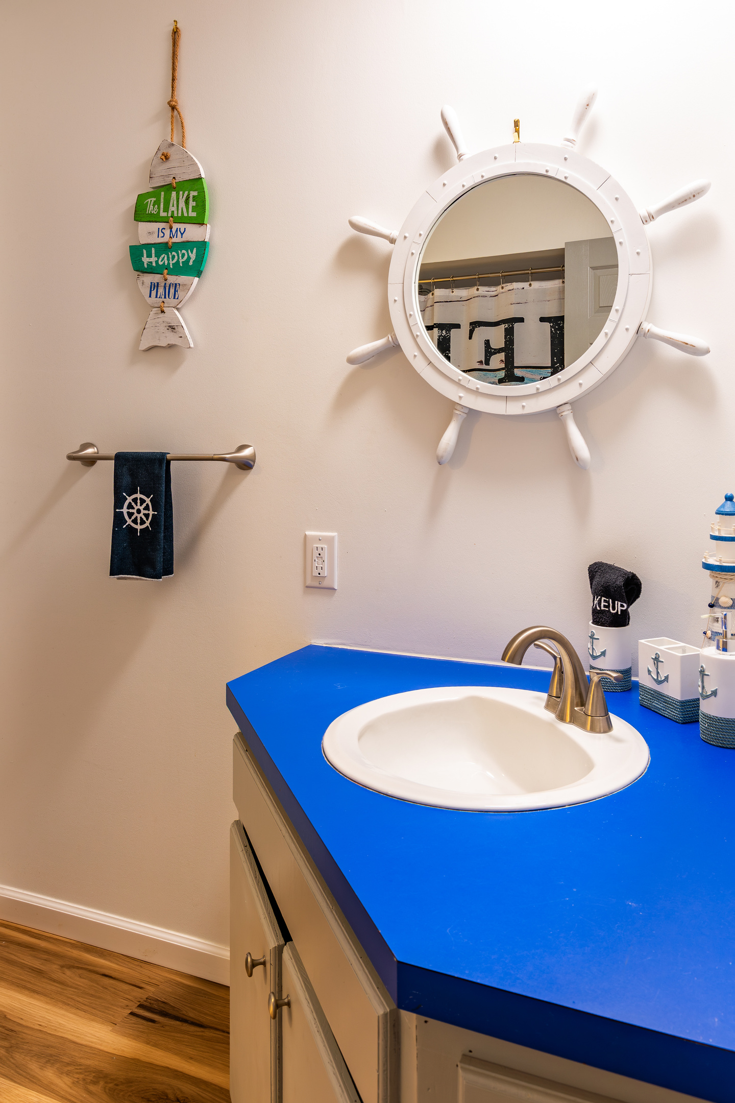 The downstairs common bathroom adds cheerful nautical details and another convenient sink area.