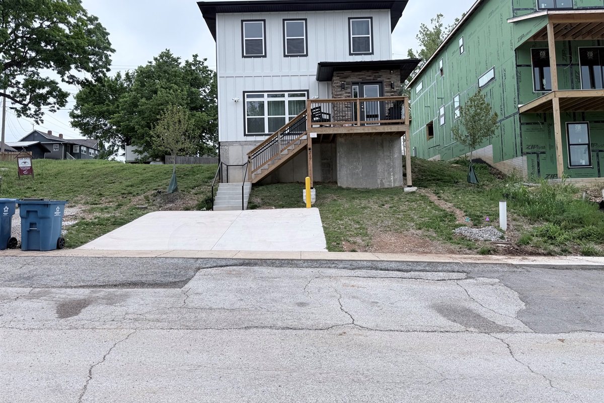 Front elevation with parking for 2 in driveway, more parking in rear as well as road.