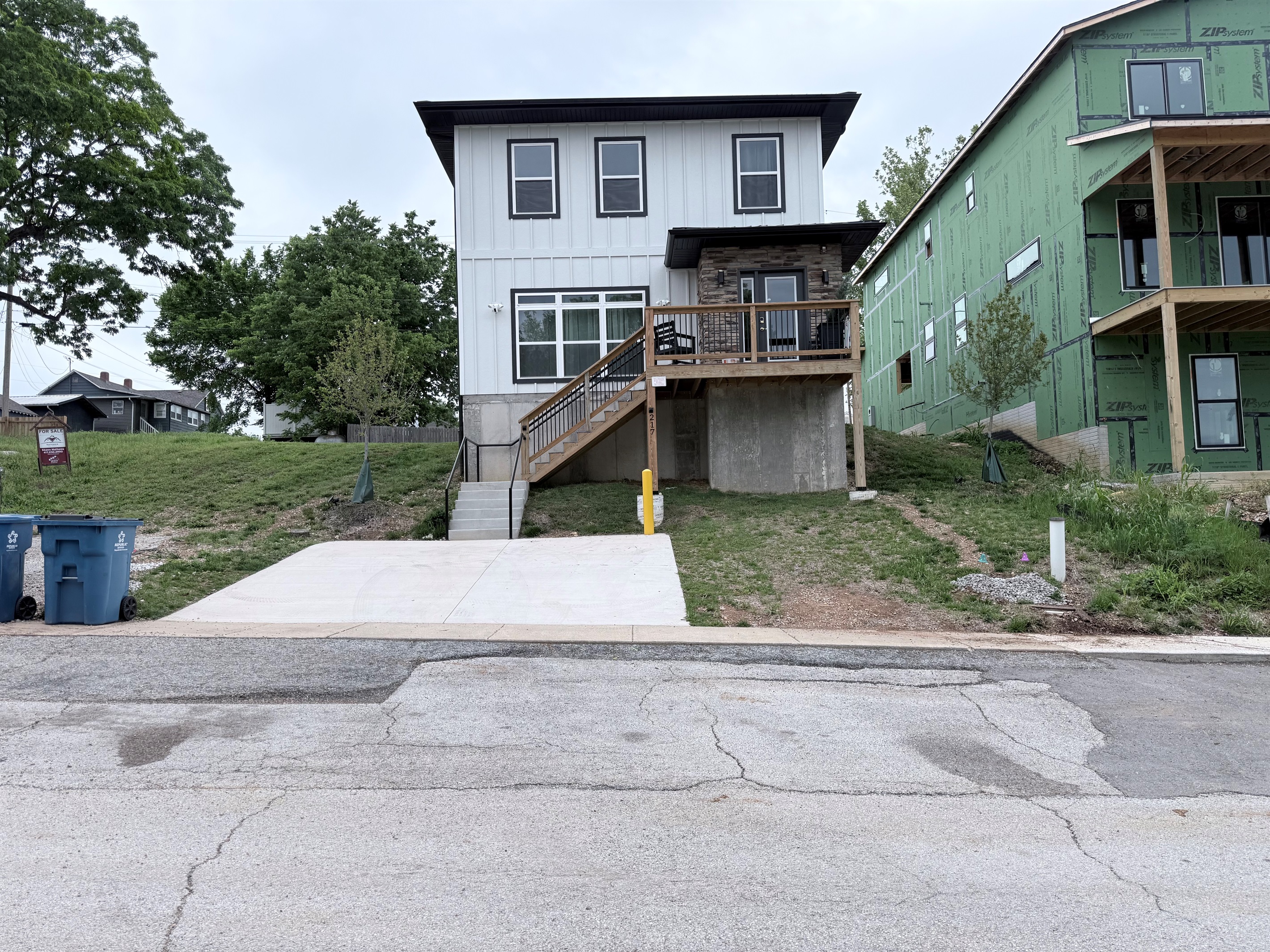 Front elevation with parking for 2 in driveway, more parking in rear as well as road.