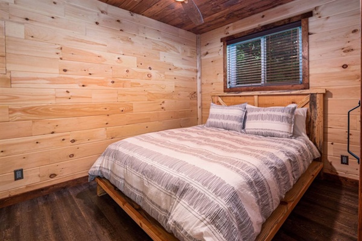 Comfortable bedroom with rustic wood finishes