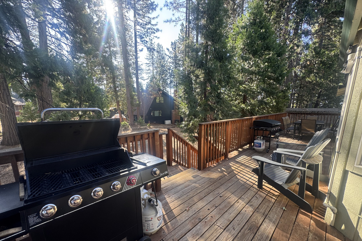 Back deck with beautiful view of open yard. Propane BBQ, Blackstone and seating for 8.
