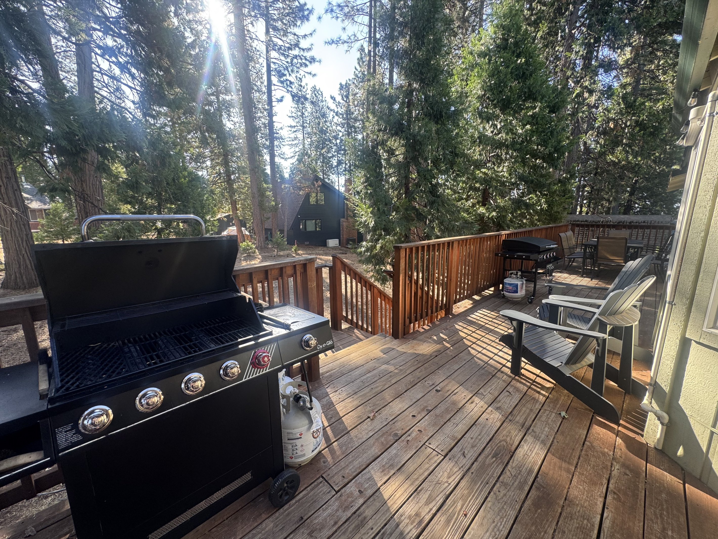 Back deck with beautiful view of open yard. Propane BBQ, Blackstone and seating for 8.
