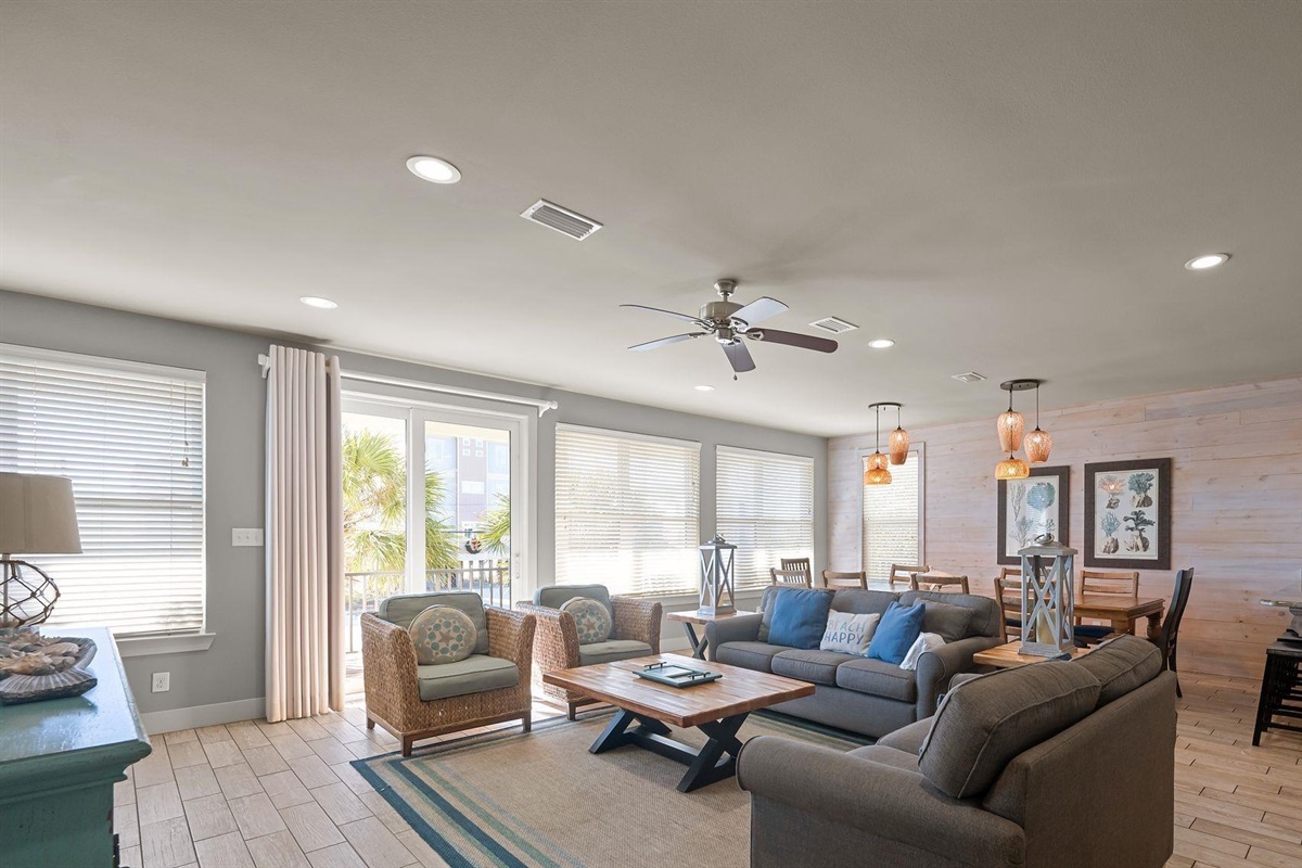 Living room area with plenty of seating and wall mounted Smart TV. Guests must log in to their own streaming services