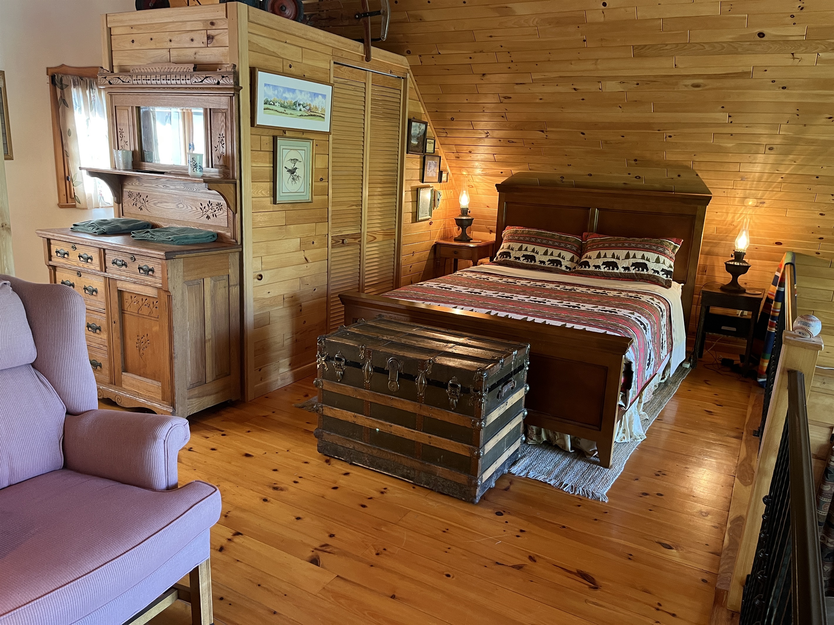 Queen bed and seating area in sleeping loft