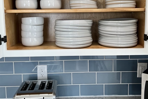 The kitchen includes both everyday ceramic dinnerware and convenient non-breakable bowls and dishes ideal for lakeside dining, kids, and outdoor use.