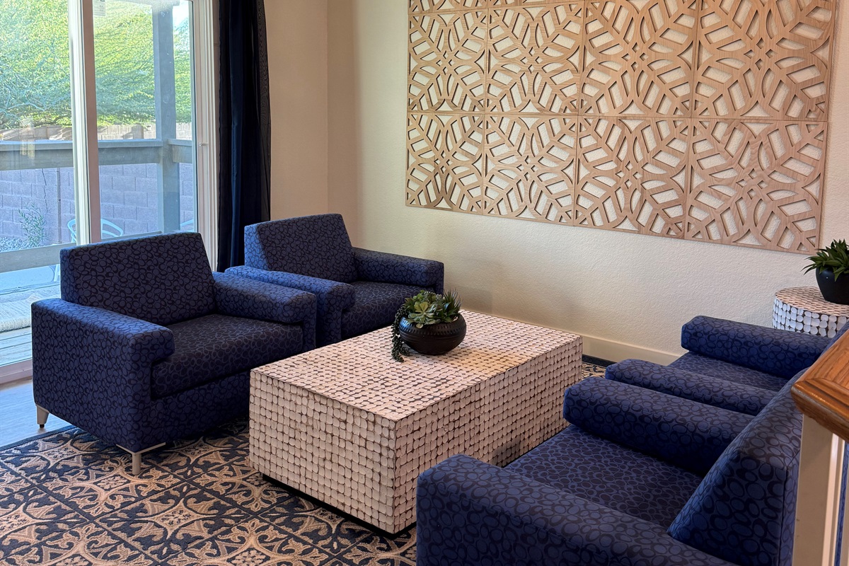 Just one of many gathering areas, this hip lounge has four arm chairs and connects to deck/balcony overlooking the pool & fire pit.