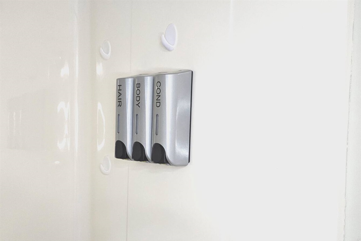 Shampoo, conditioner, and body wash dispensers are provided in each bathroom. 
