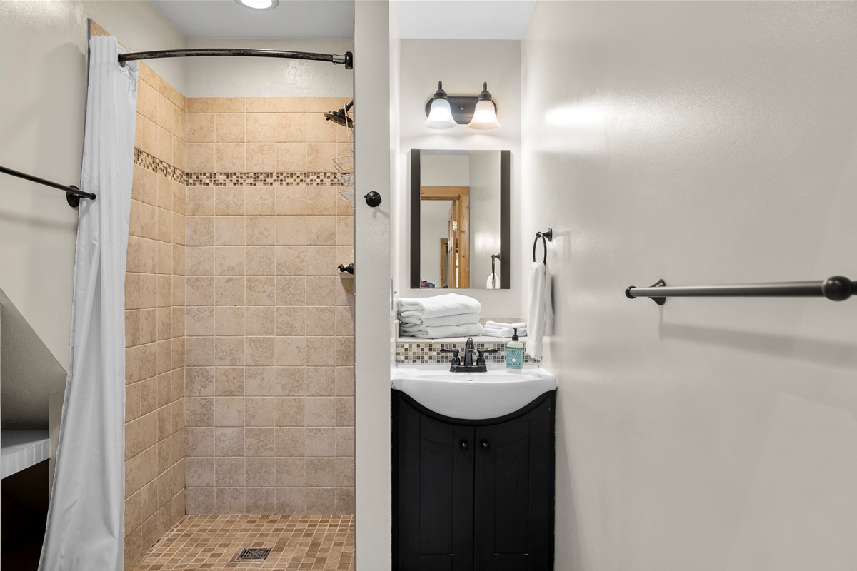 Bathroom Retreat: Discover sleek design with a chic walk-in shower and stylish amenities!