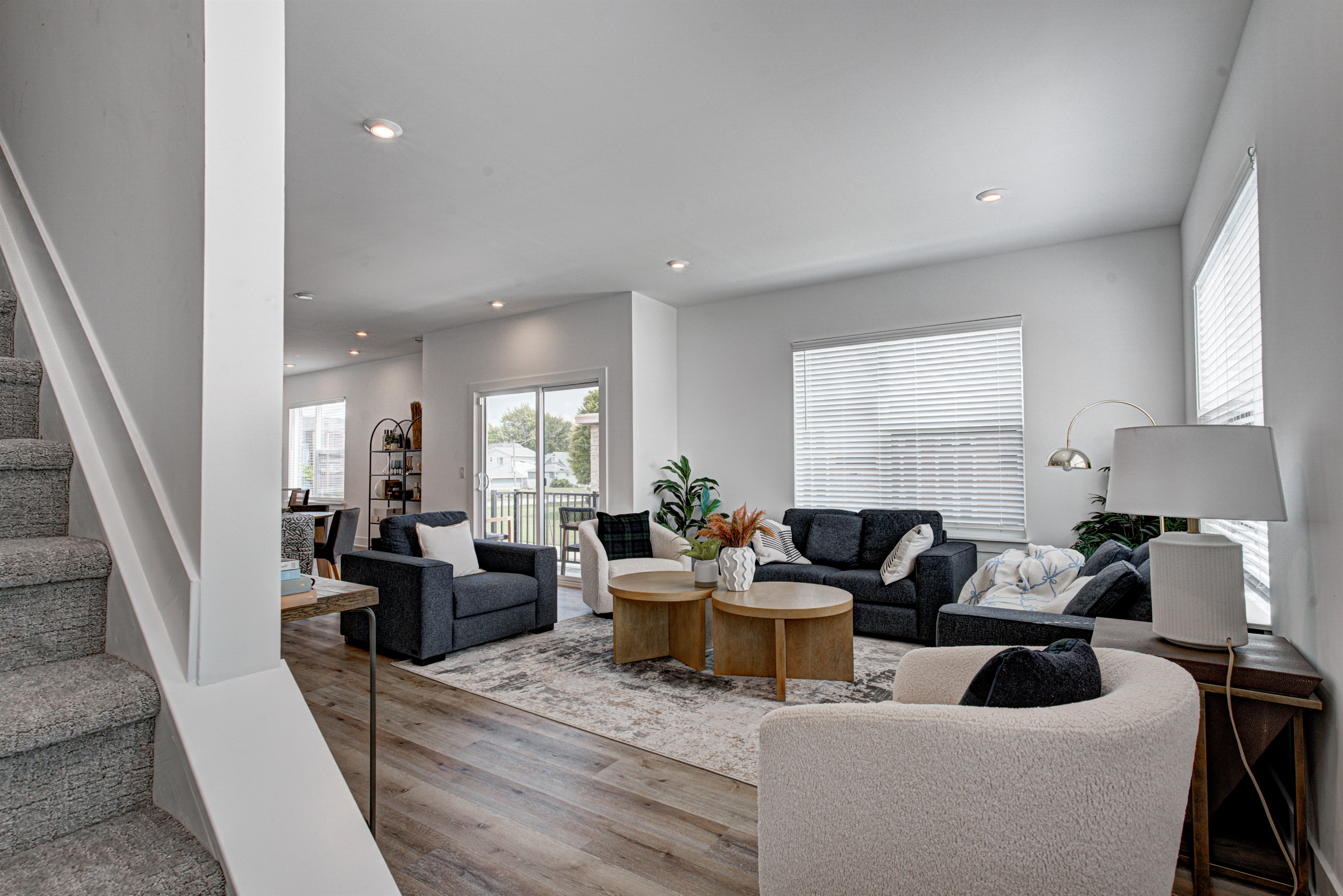 Enjoy a designed open-concept space with a modern kitchen equipped with quartz countertops, stainless steel appliances, and all essentials for home cooking. 