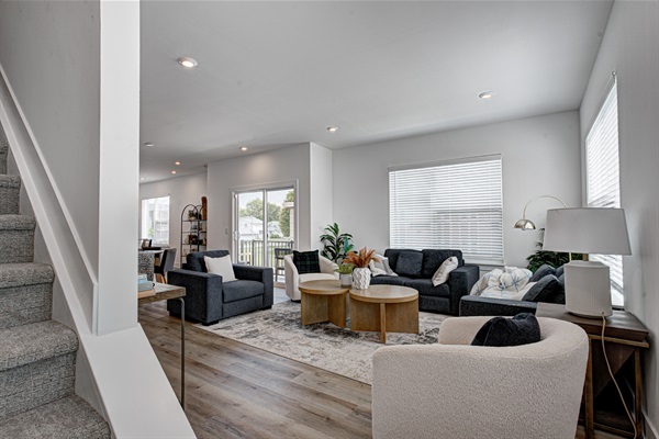 Enjoy a designed open-concept space with a modern kitchen equipped with quartz countertops, stainless steel appliances, and all essentials for home cooking. 