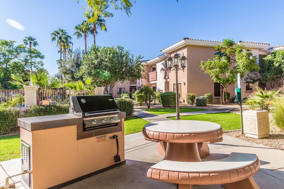 Gas grill and seating near the condo.