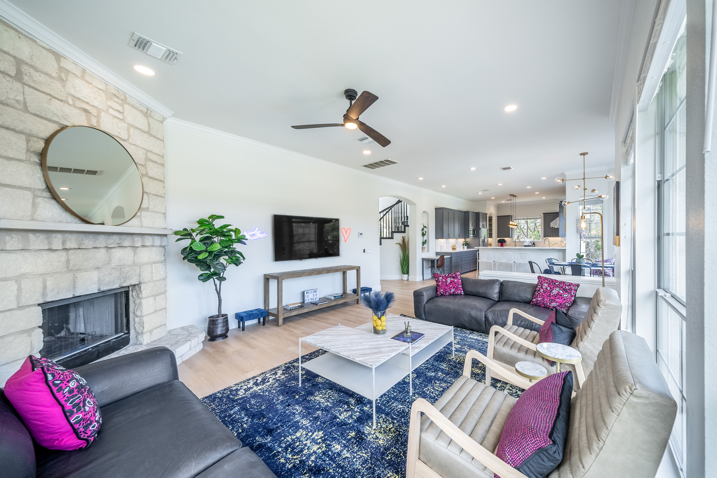 Ceiling fan and fireplace bring comfort to this bright living space.