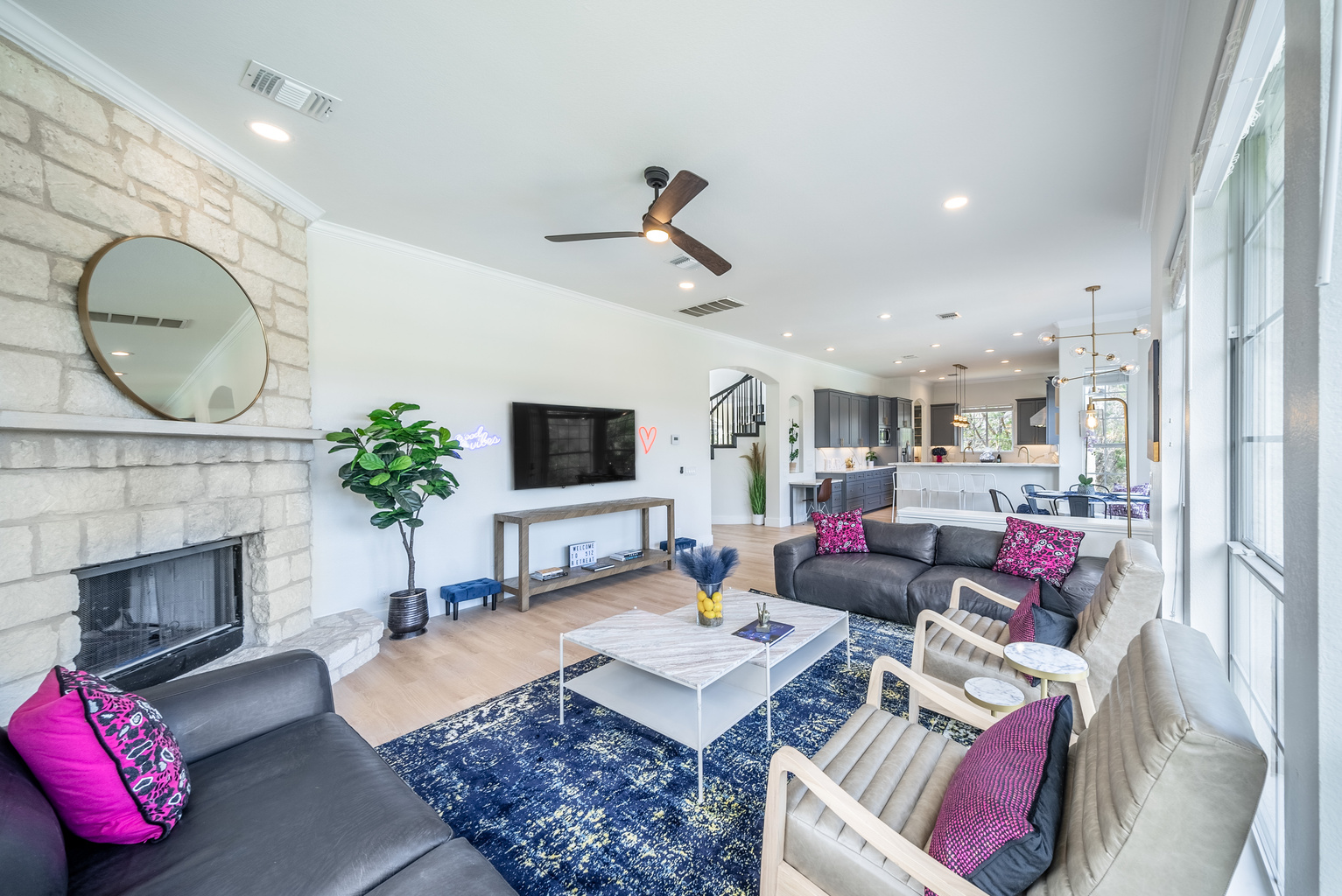 Ceiling fan and fireplace bring comfort to this bright living space.
