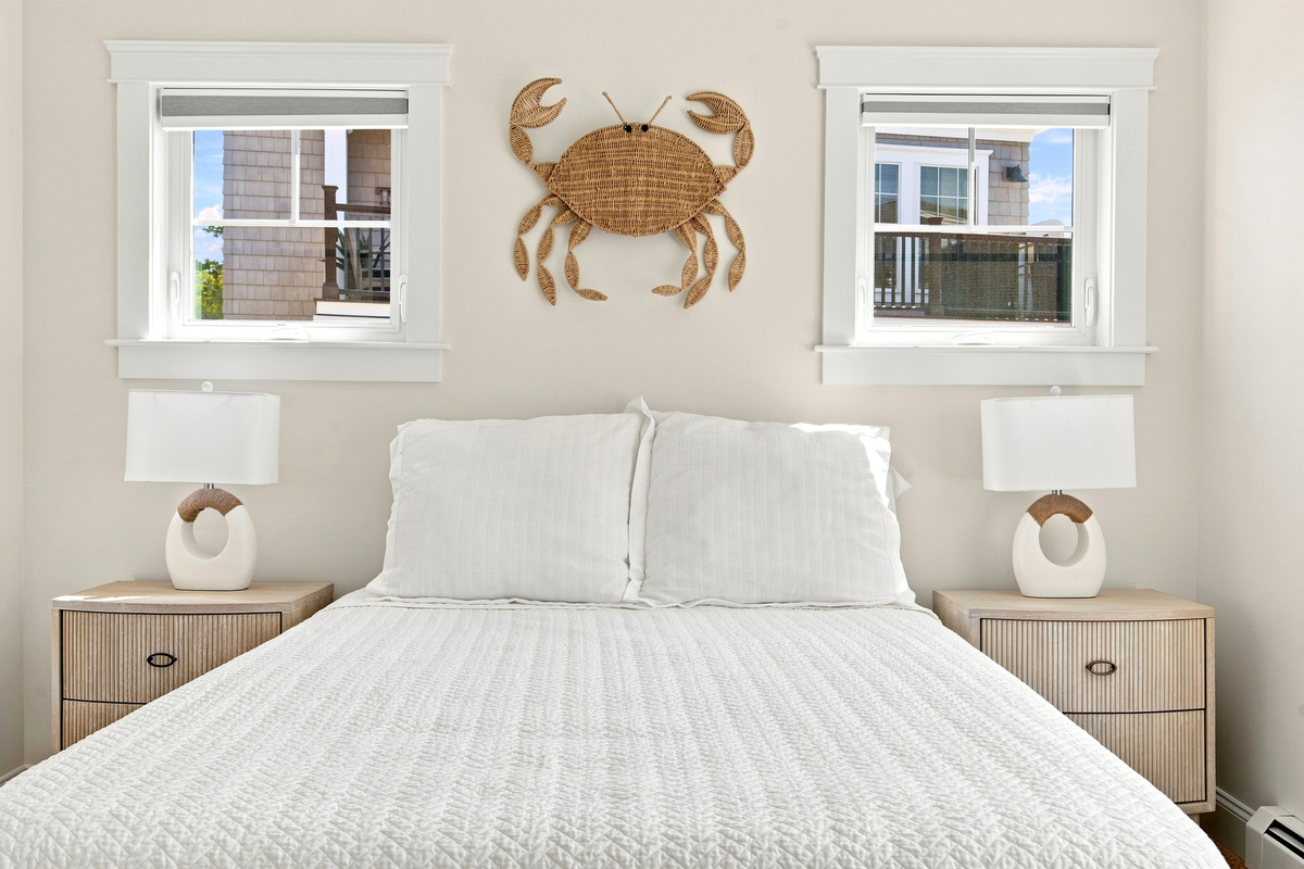 Coastal character and natural light create a welcoming bedroom retreat with a playful seaside touch.
