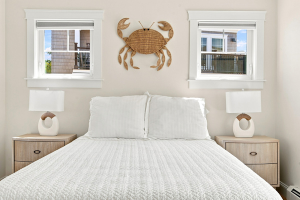 Coastal character and natural light create a welcoming bedroom retreat with a playful seaside touch.