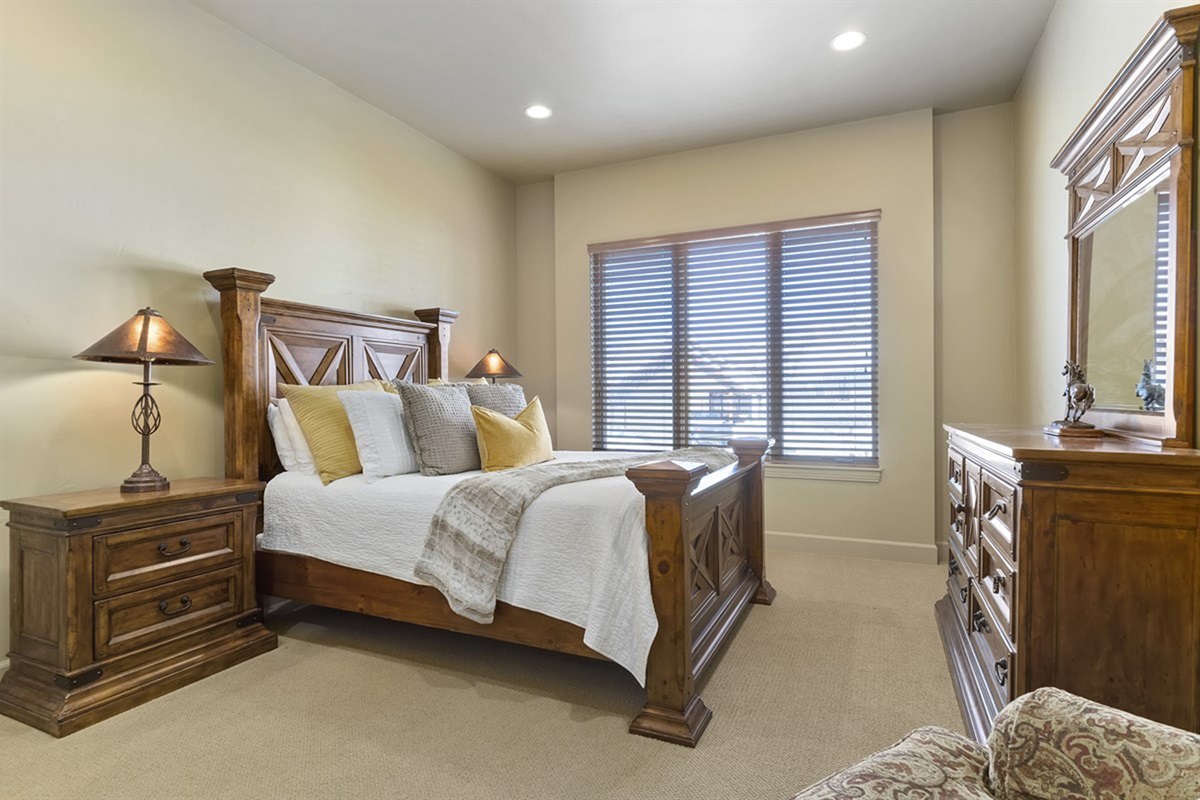 A comfortable guest bedroom with a plush bed and calming atmosphere for a great night’s sleep.