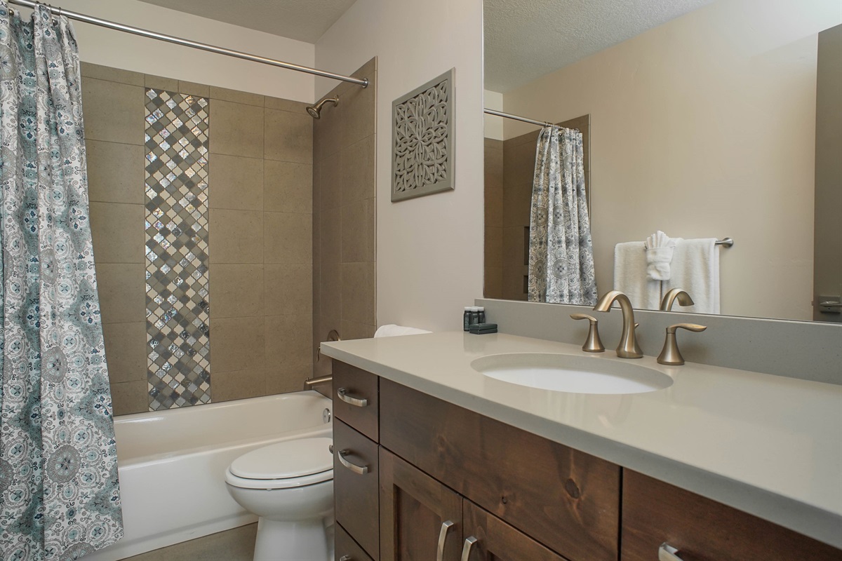 A well-appointed guest bathroom upstairs with modern finishes and a fresh, clean design.