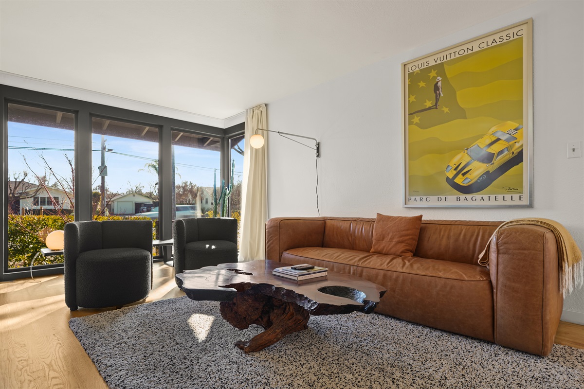 Gather and unwind in the spacious living room featuring comfortable seating, a Smart TV, and an inviting atmosphere perfect for relaxing with family and friends.