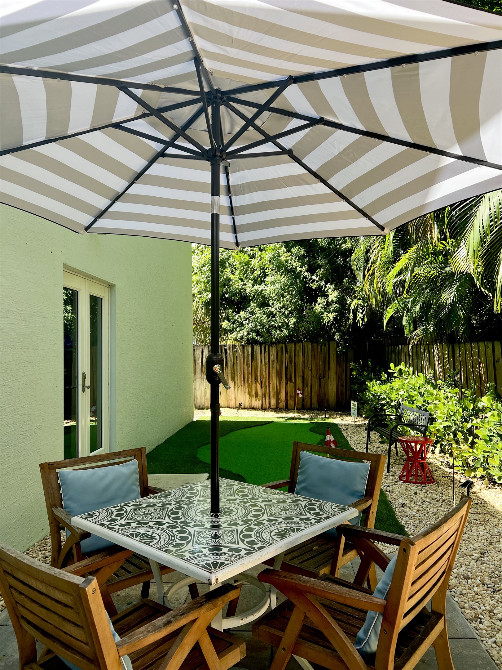 Mini putting green and shaded seating area, just out the kitchen’s French doors.