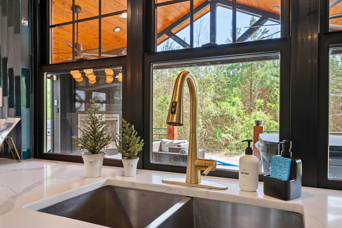 The large sink area offers a scenic view outside, turning everyday moments like washing dishes into something a little more enjoyable.
