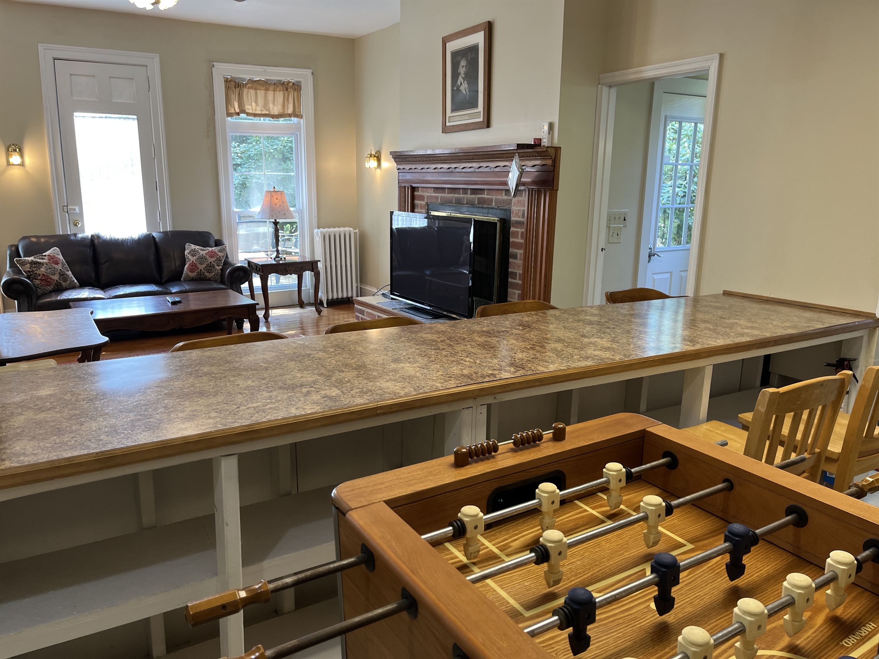 View into the living room from behind the bar. The door to the right leads outside to the deck and grill.