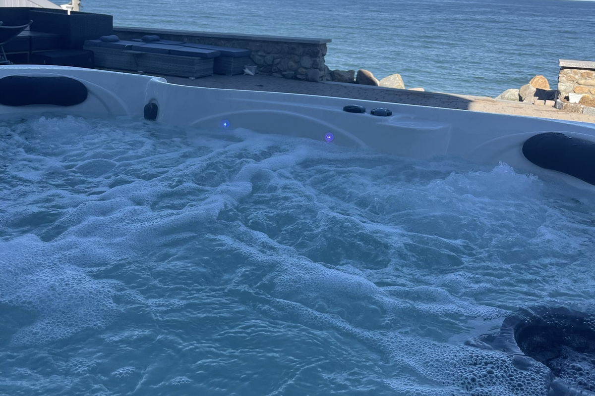 Unwind in the bubbling hot tub and take in the beautiful oceanfront scenery.