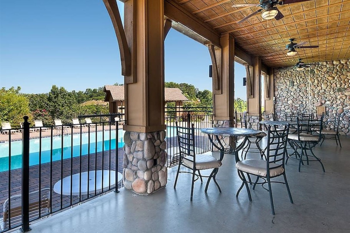 - Covered poolside patio with stone walls and mountain-view seating   - Enjoy shaded comfort while staying close to the sparkling pool   - Relax, dine, or unwind while surrounded by mountain serenity