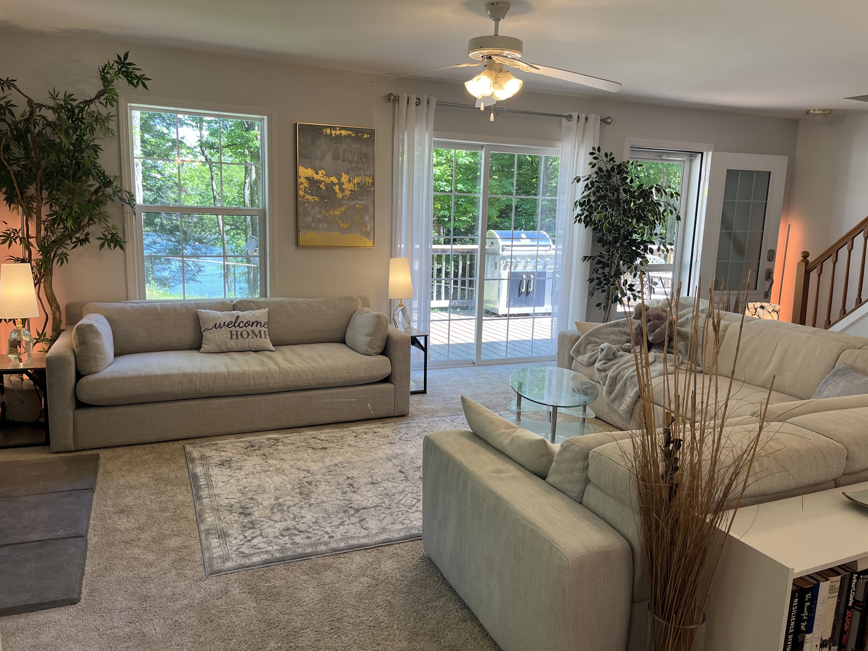 Living room with silders to deck and lakeview