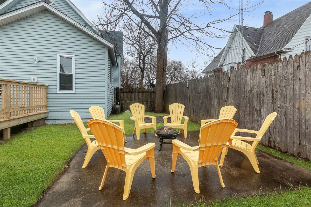 Roast a s'more in the backyard firepit. (The fenced-in backyard hosts a deck with rocking furniture for four, along with a firepit surrounded by eight Adirondack chairs on the patio.)