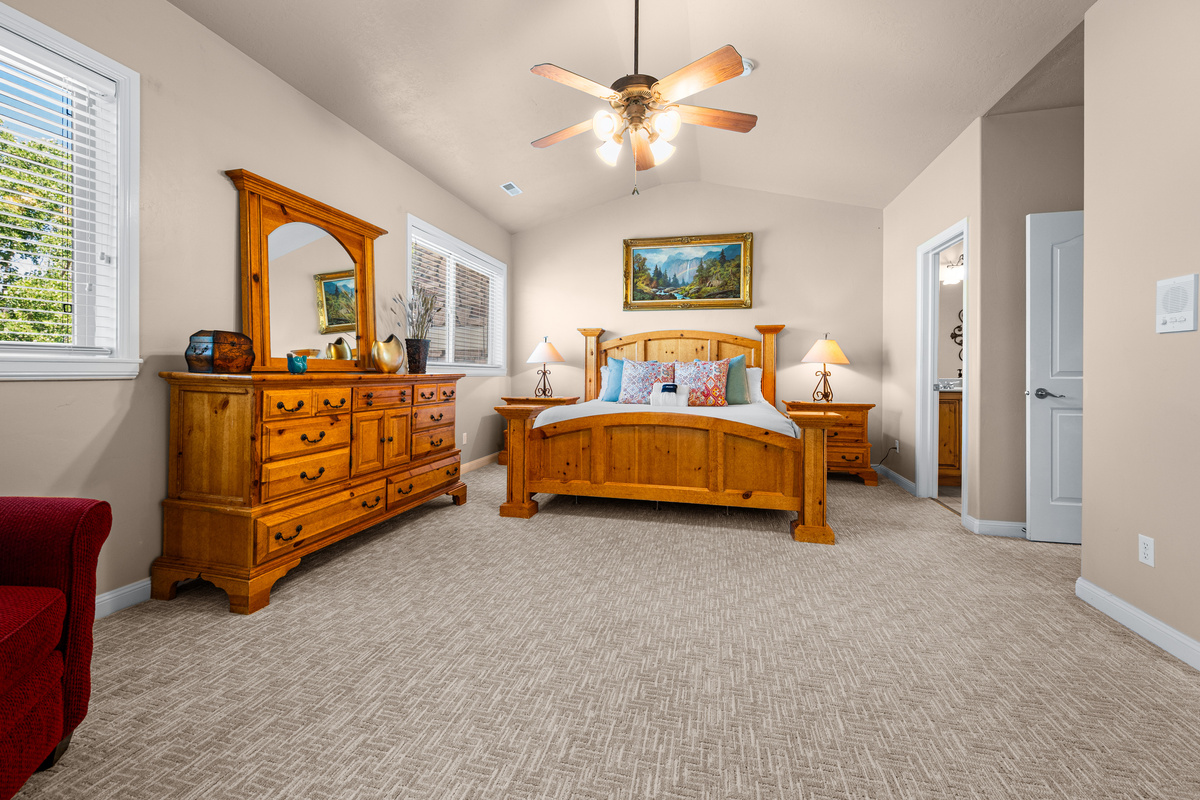 Elegant primary bedroom with quality furnishings and plenty of room to relax.