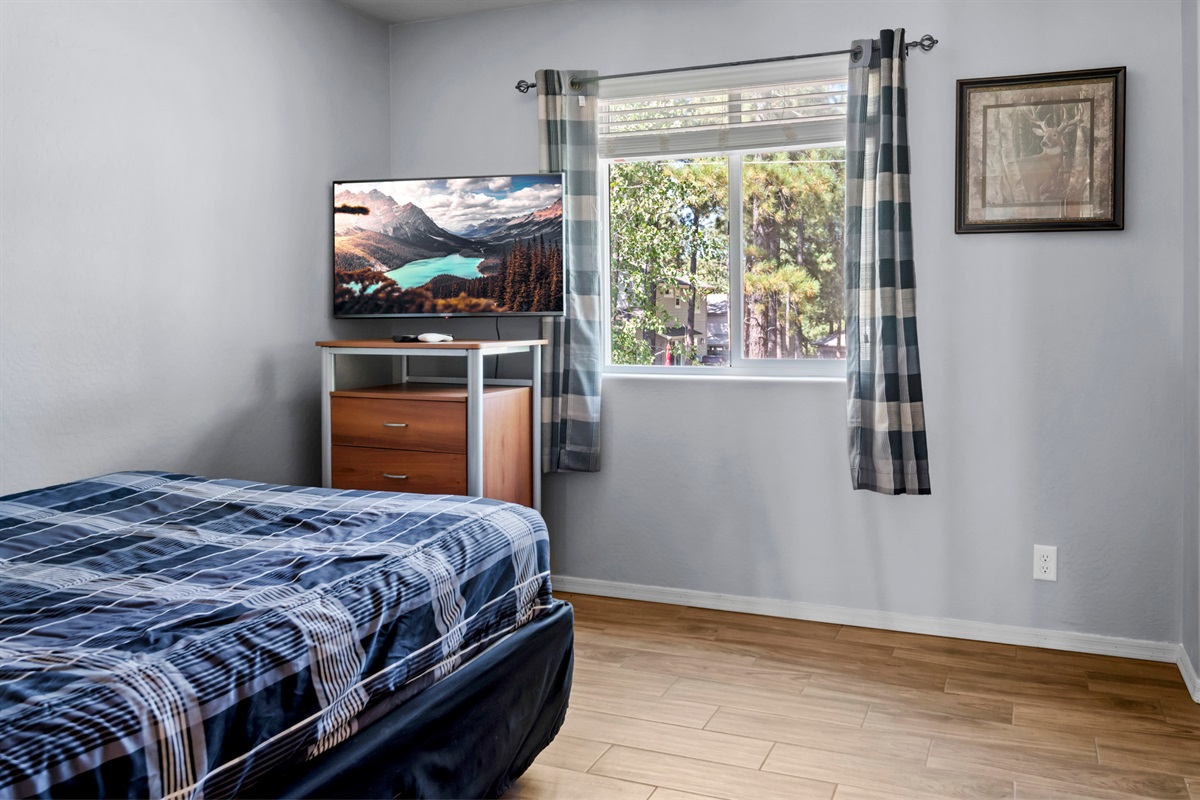 The second bedroom, featuring a TV for entertainment, and a dresser for your belongings.