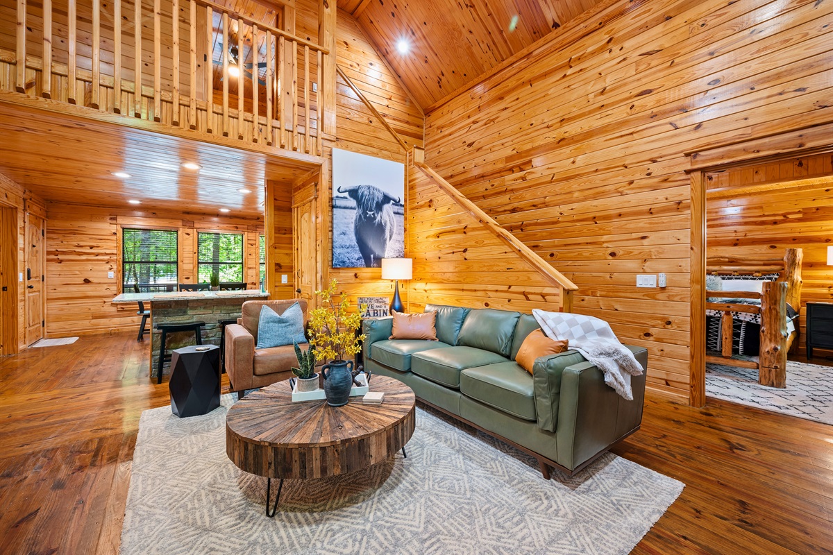 Open living space below the loft with plush furniture and ambient lighting for relaxing and entertaining.