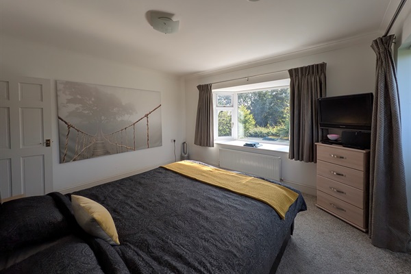 Big bay window to 1 side and balcony to the other side.