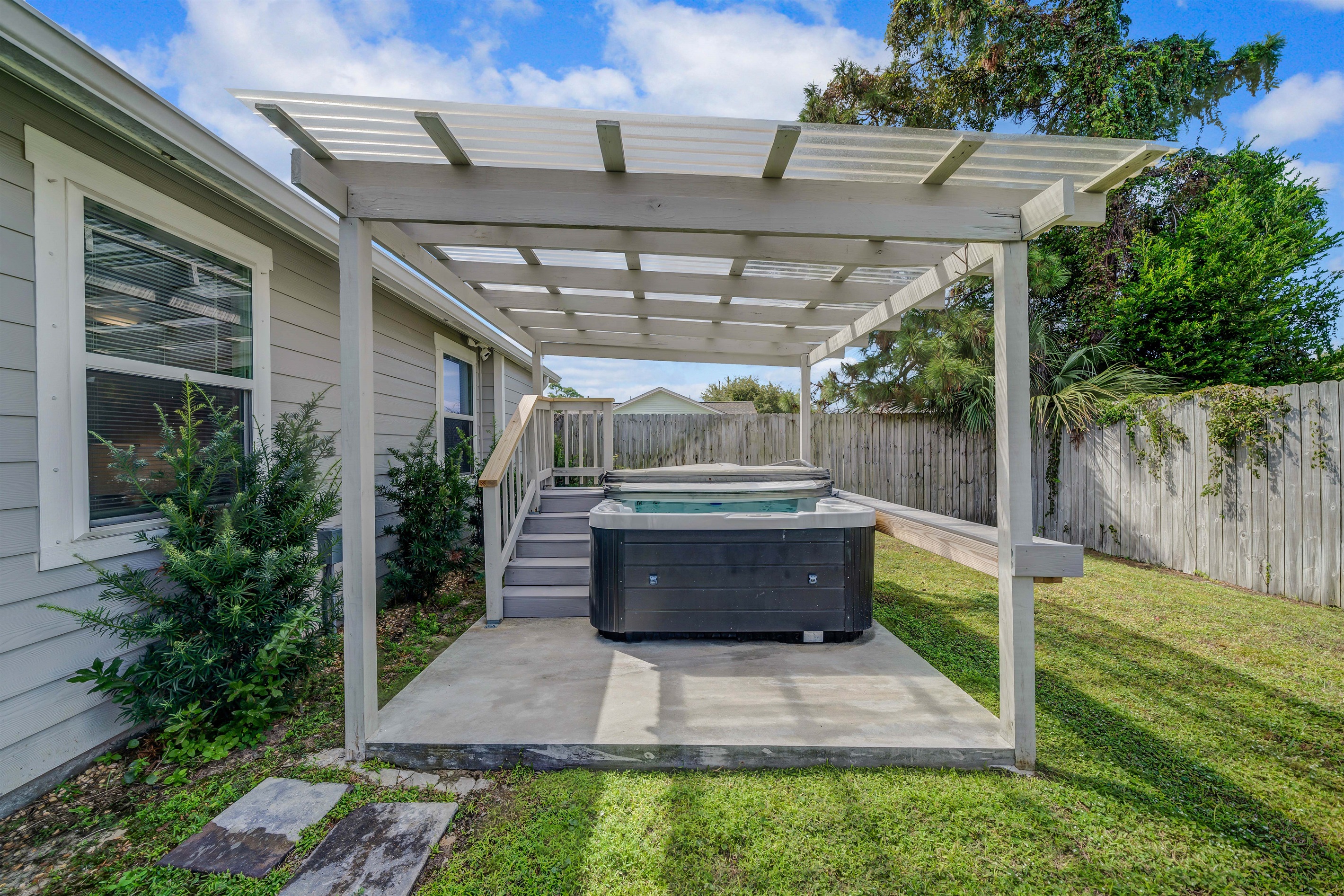 Soak your tired muscles in the warm water after a full day of exploring. A tall wooden fence surrounds the backyard to give you total privacy. You can relax out here in complete peace.