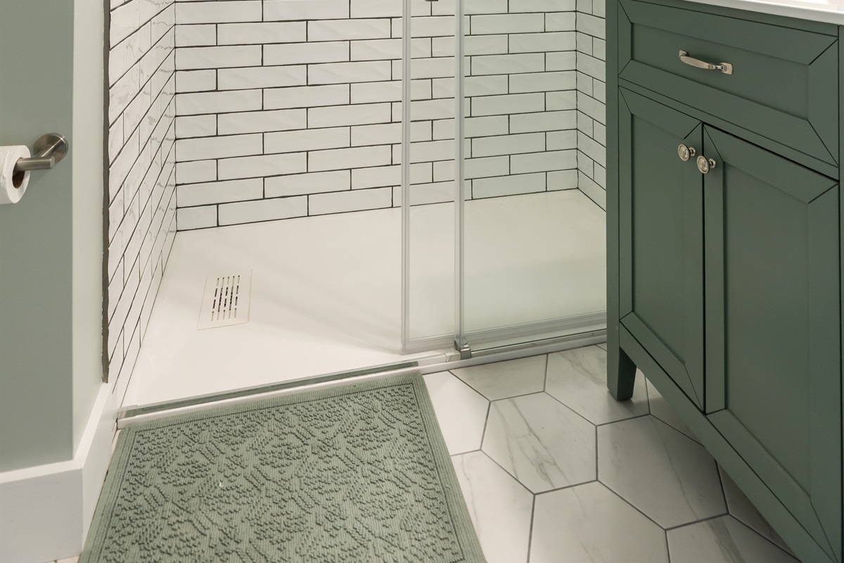 Tiled shower and vanity offer a great bathroom between bedroom 3 and 2.