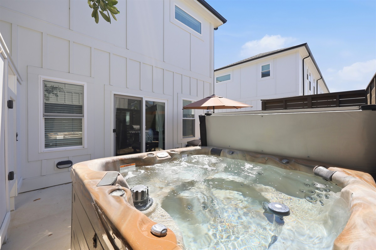 Private outdoor hot tub perfect for relaxing after a beach day