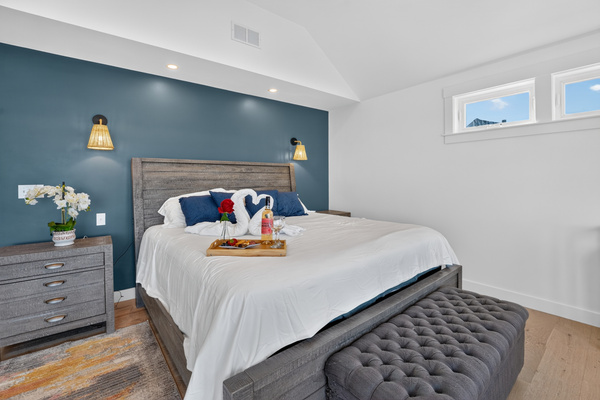 Elegant bedroom with coastal-inspired décor, plush bedding, and a relaxing atmosphere