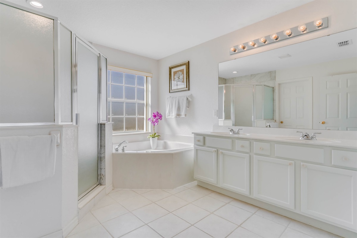 The master bath has lots of light and double sinks for convenience.